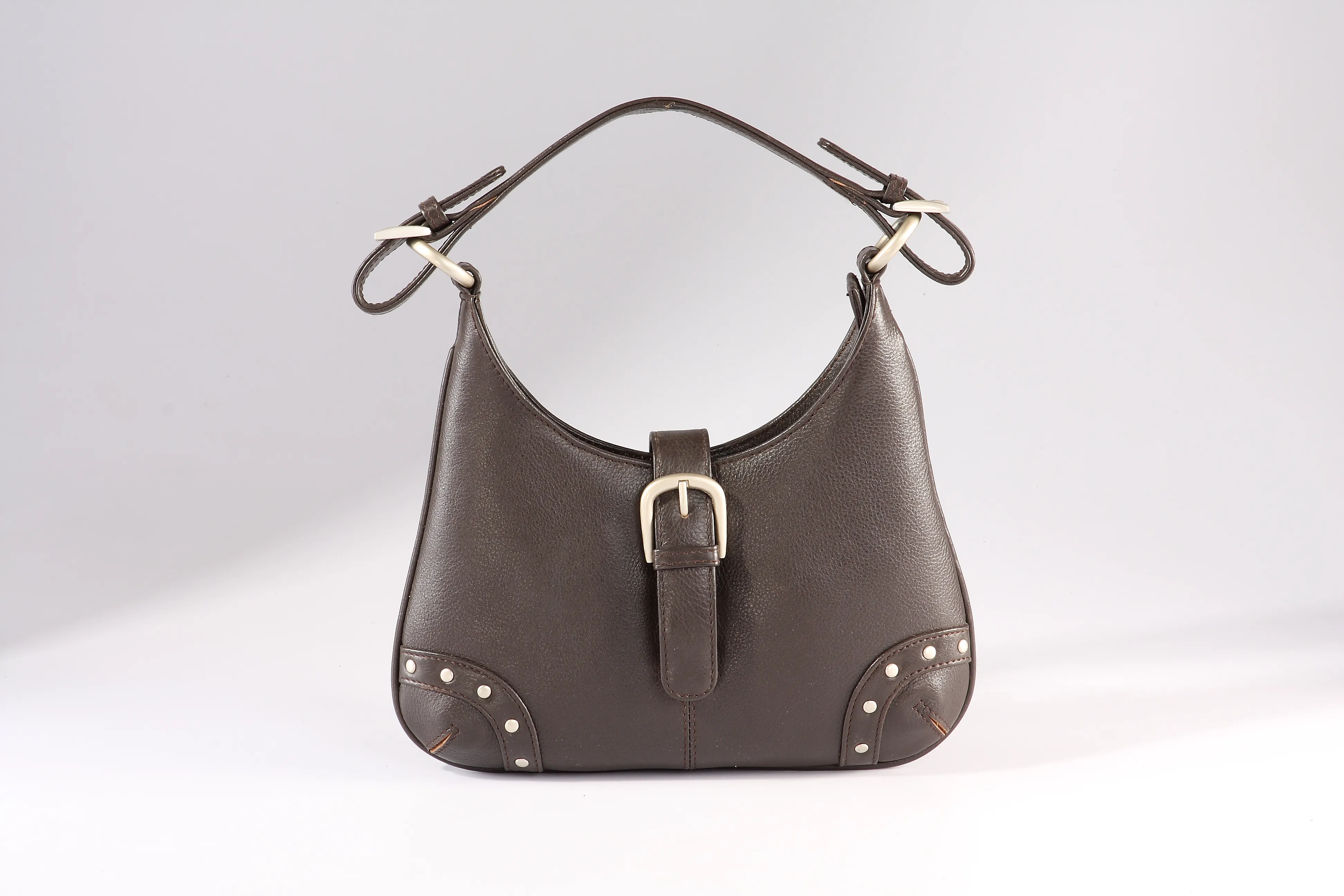 Black Nappa leather hobo bag with studded rivets, and a brass buckle flap.